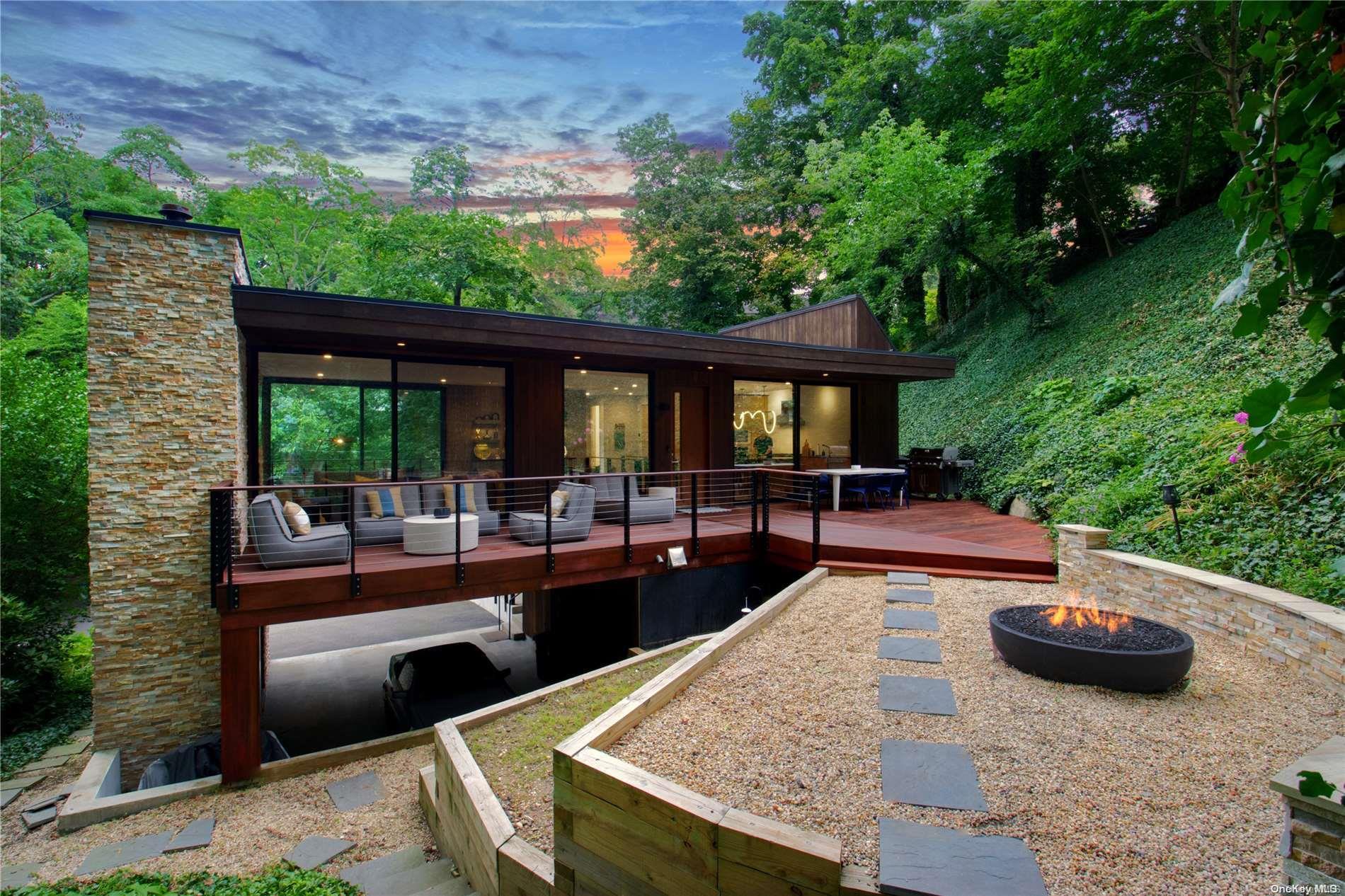 a view of a house with backyard and sitting area