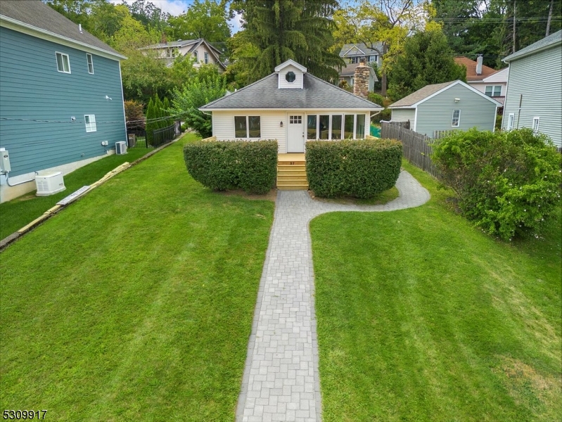 a front view of a house with garden