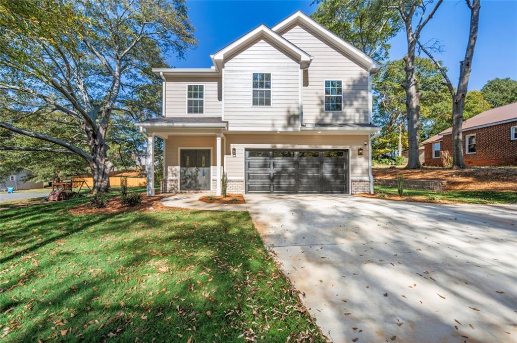 a front view of a house with a yard and garage