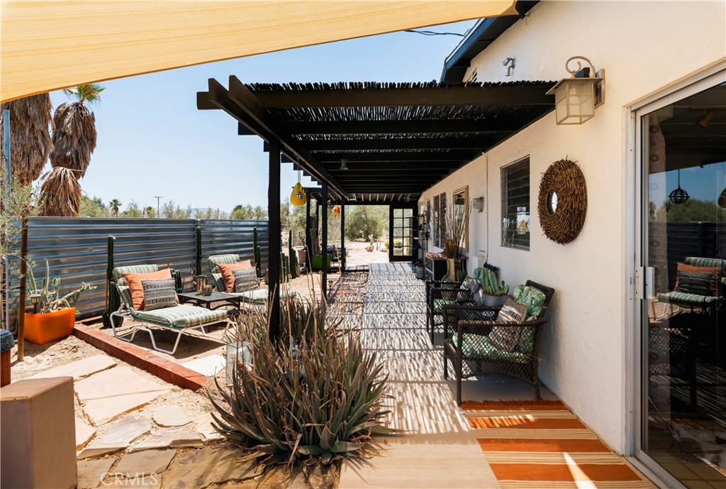 a view of a balcony with chairs and potted plants