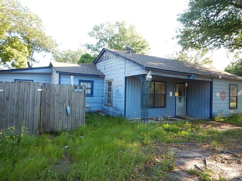 a view of a house with a yard and wooden fence