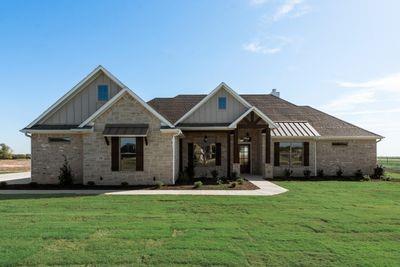 a front view of house with yard and green space