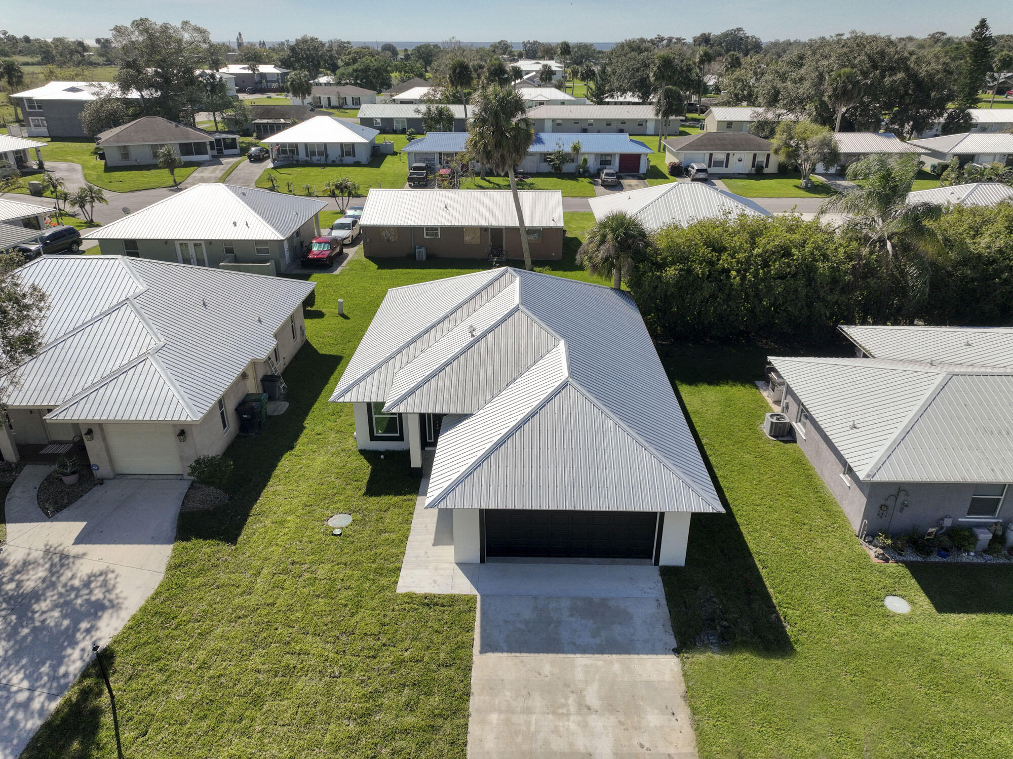 an aerial view of a house with swimming pool and lake view