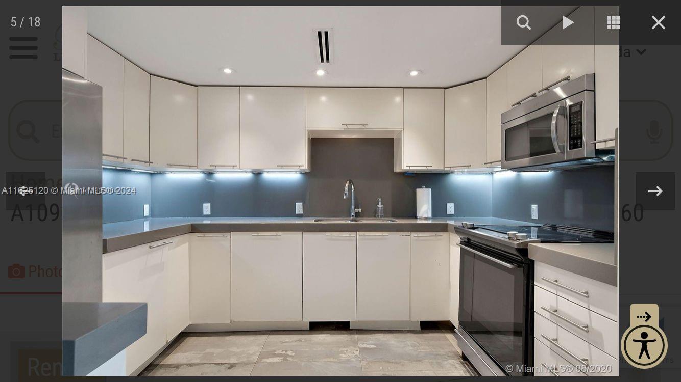 a kitchen with granite countertop a sink a stove and cabinets