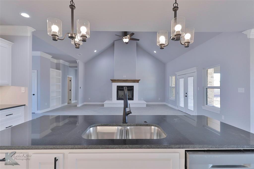 a view of a kitchen with a sink and chandelier