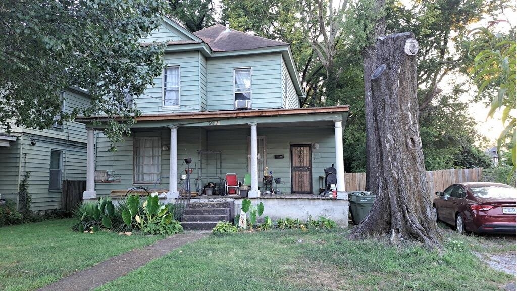 a front view of a house with a garden and plants