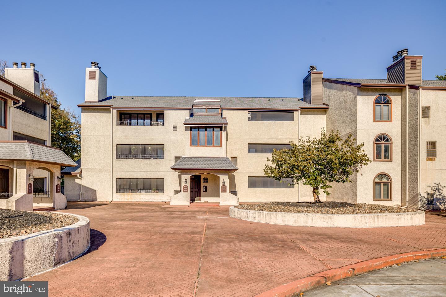 a view of a white building with a outdoor space