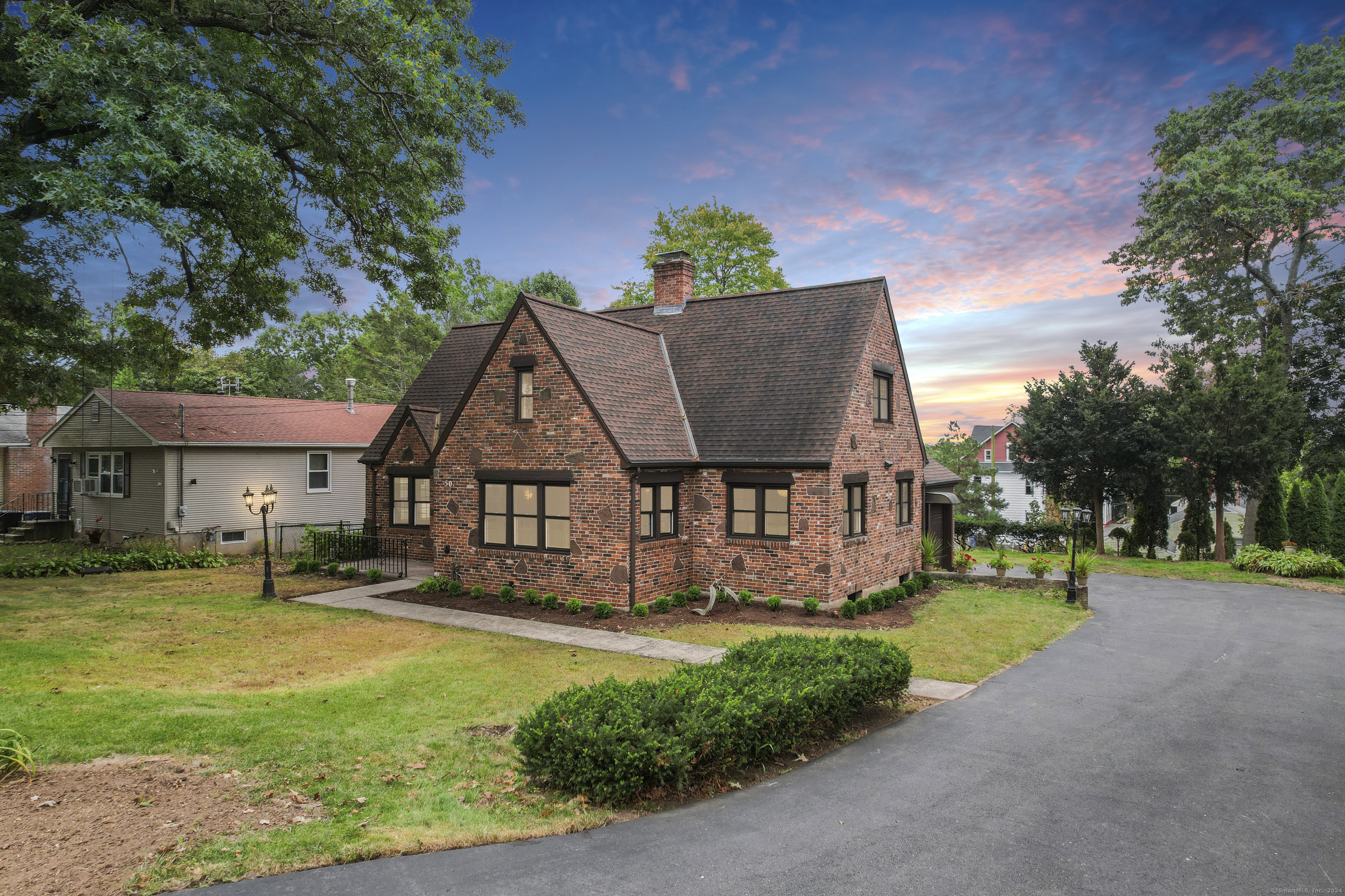 a view of a house with a yard and tree s