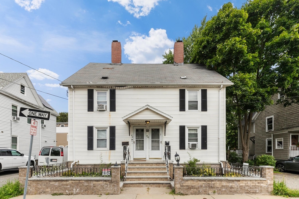 a front view of a house with a garden