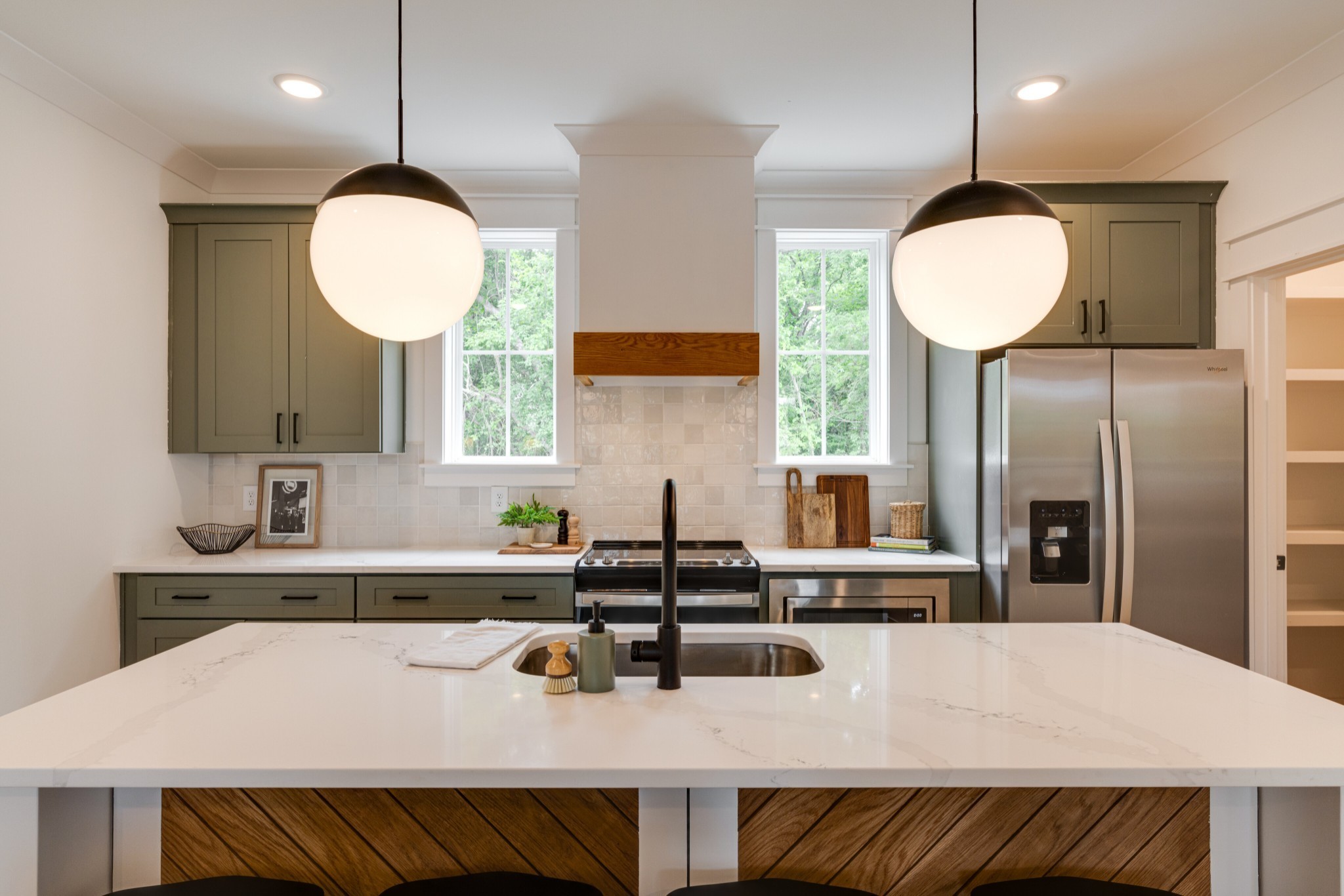 a kitchen with a table chairs sink and microwave