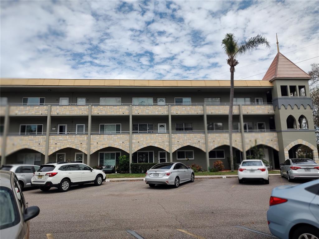 a couple of cars parked in parking area of a building