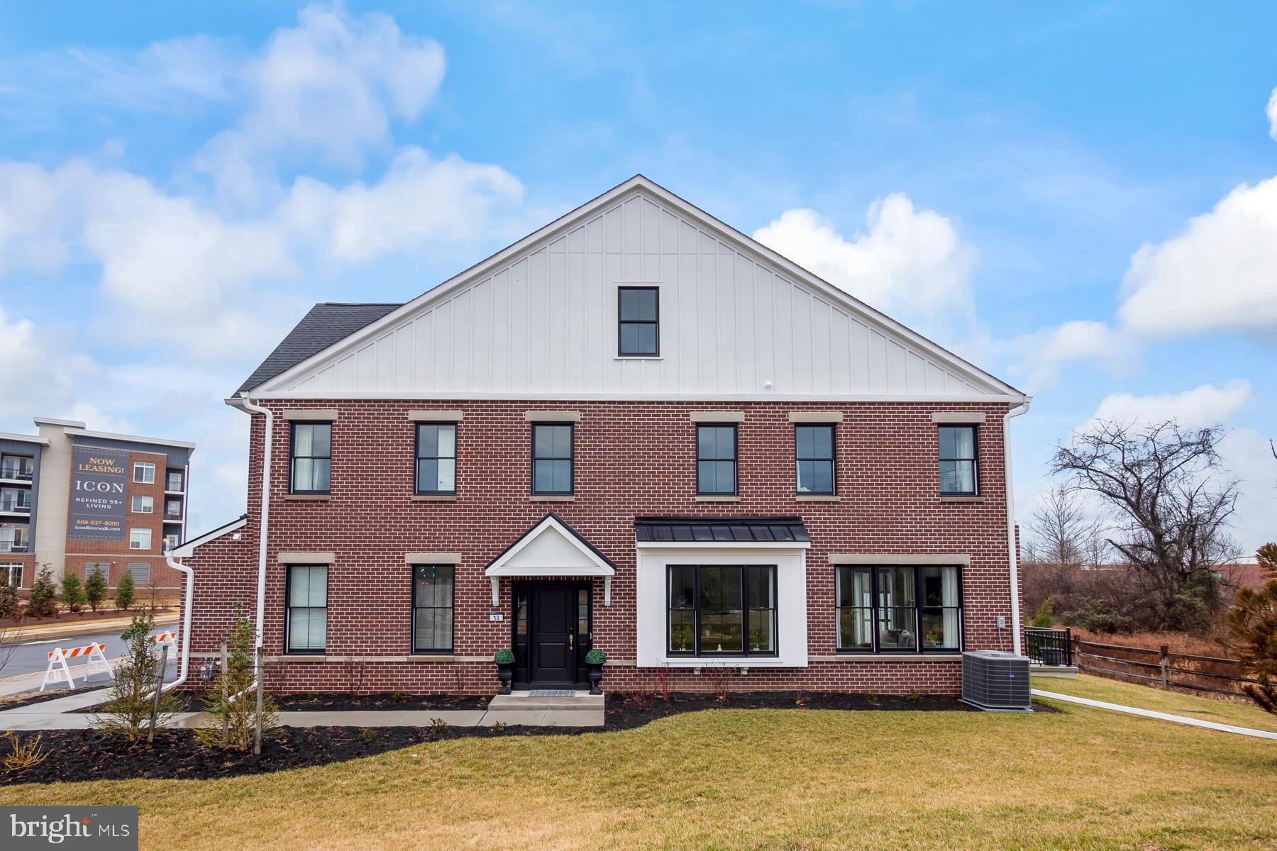 a front view of a house with large windows