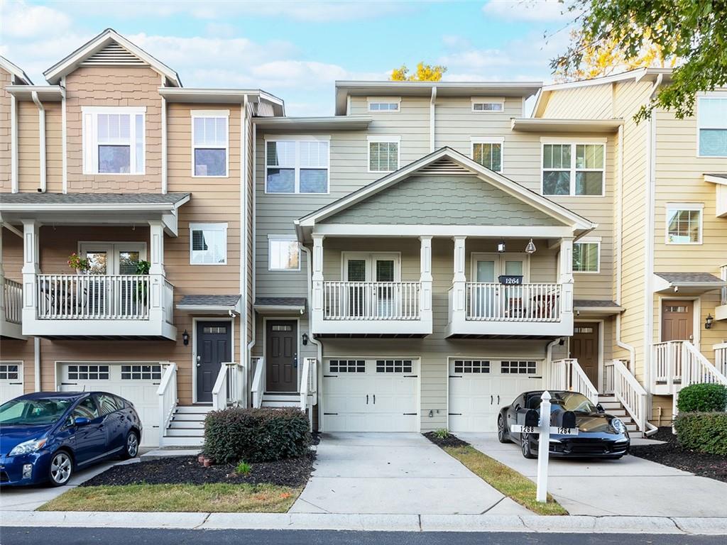 a front view of a building with cars parked in front of a house