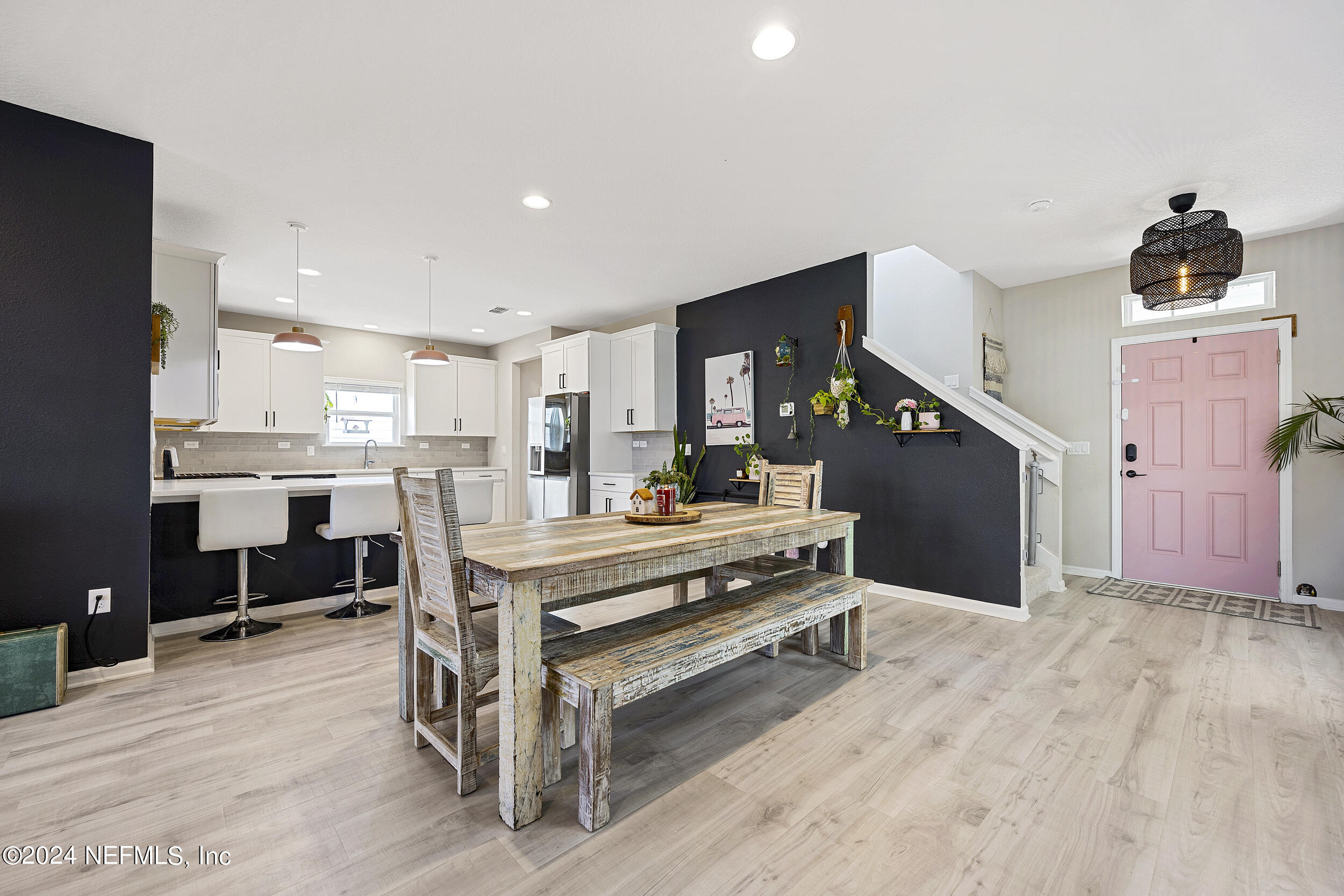 a living room with stainless steel appliances kitchen island furniture and wooden floor