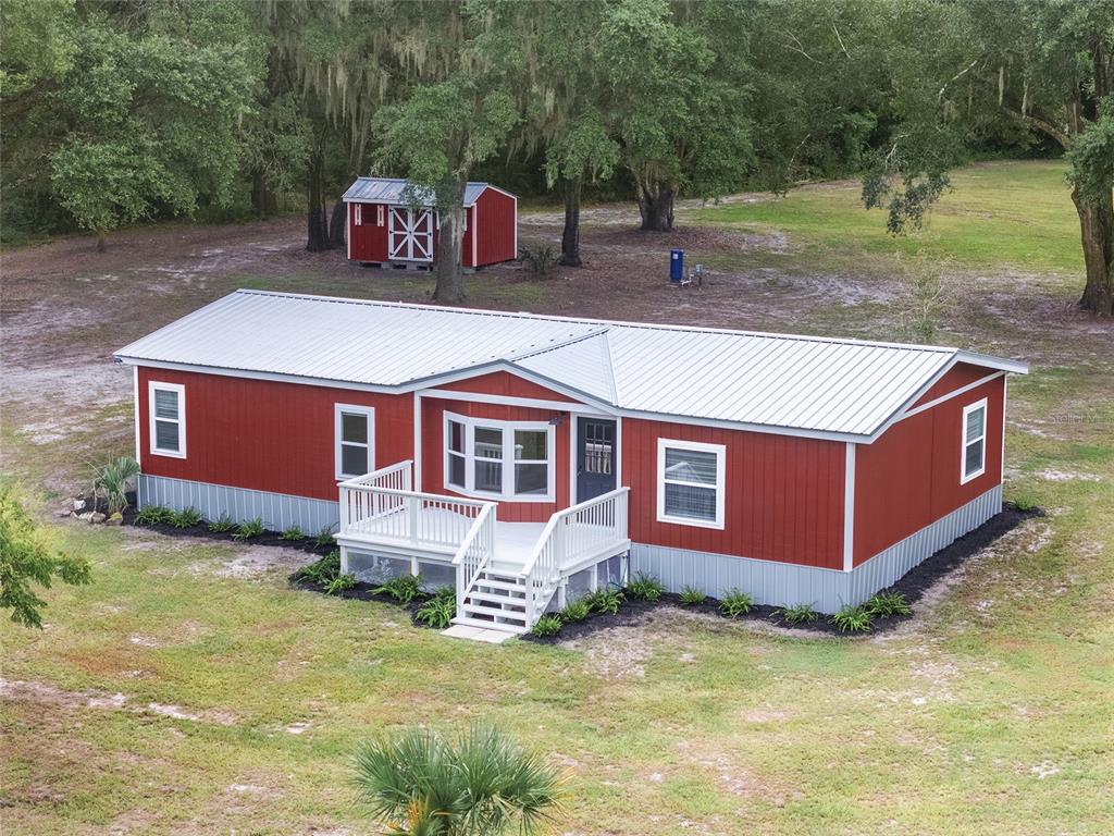 a view of a house with a yard and sitting area