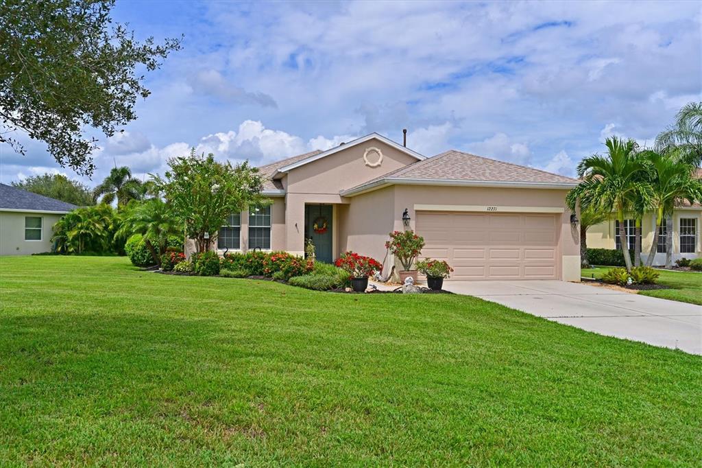 a front view of a house with a garden