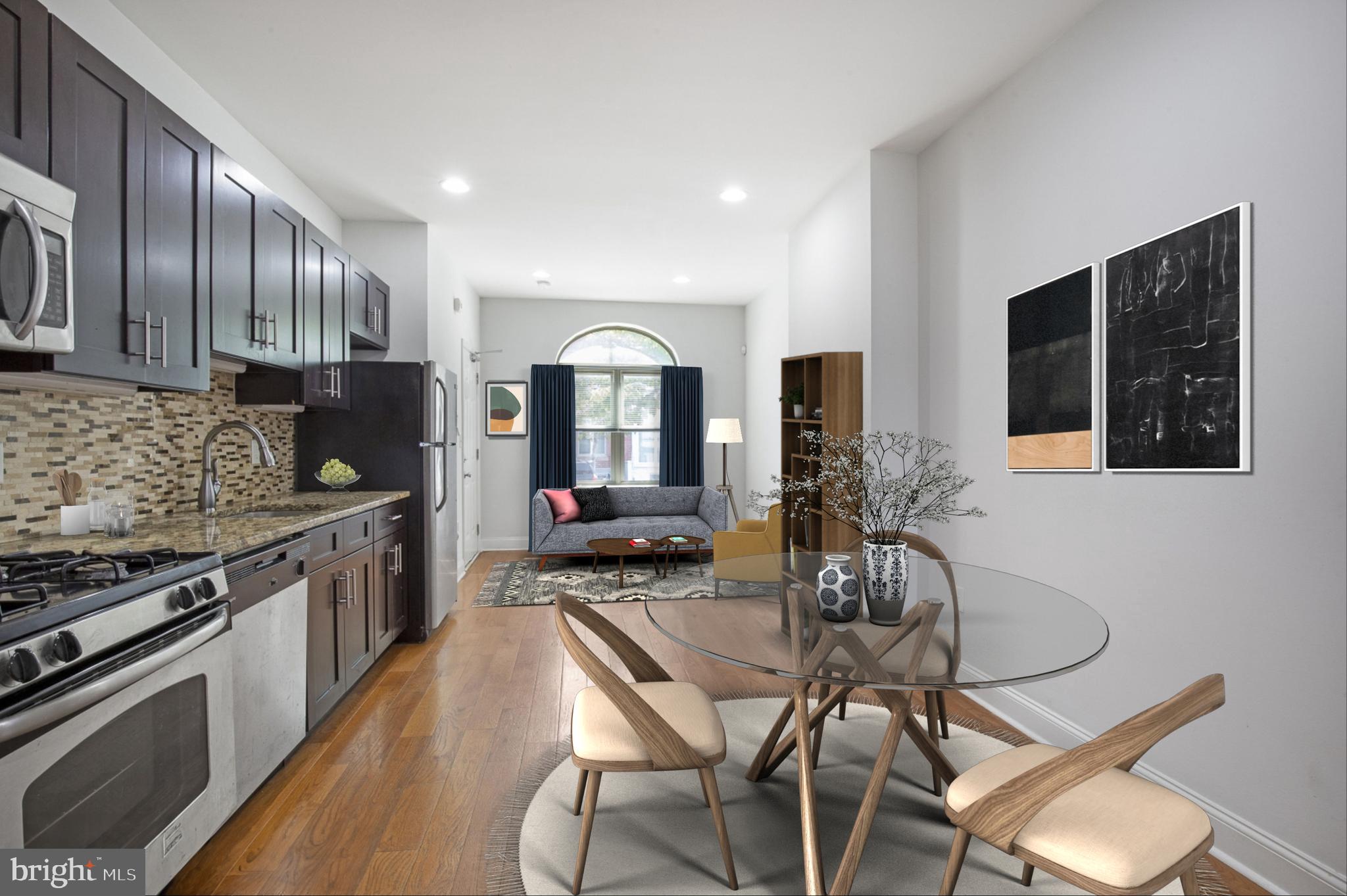 a kitchen with granite countertop a table chairs stove and cabinets