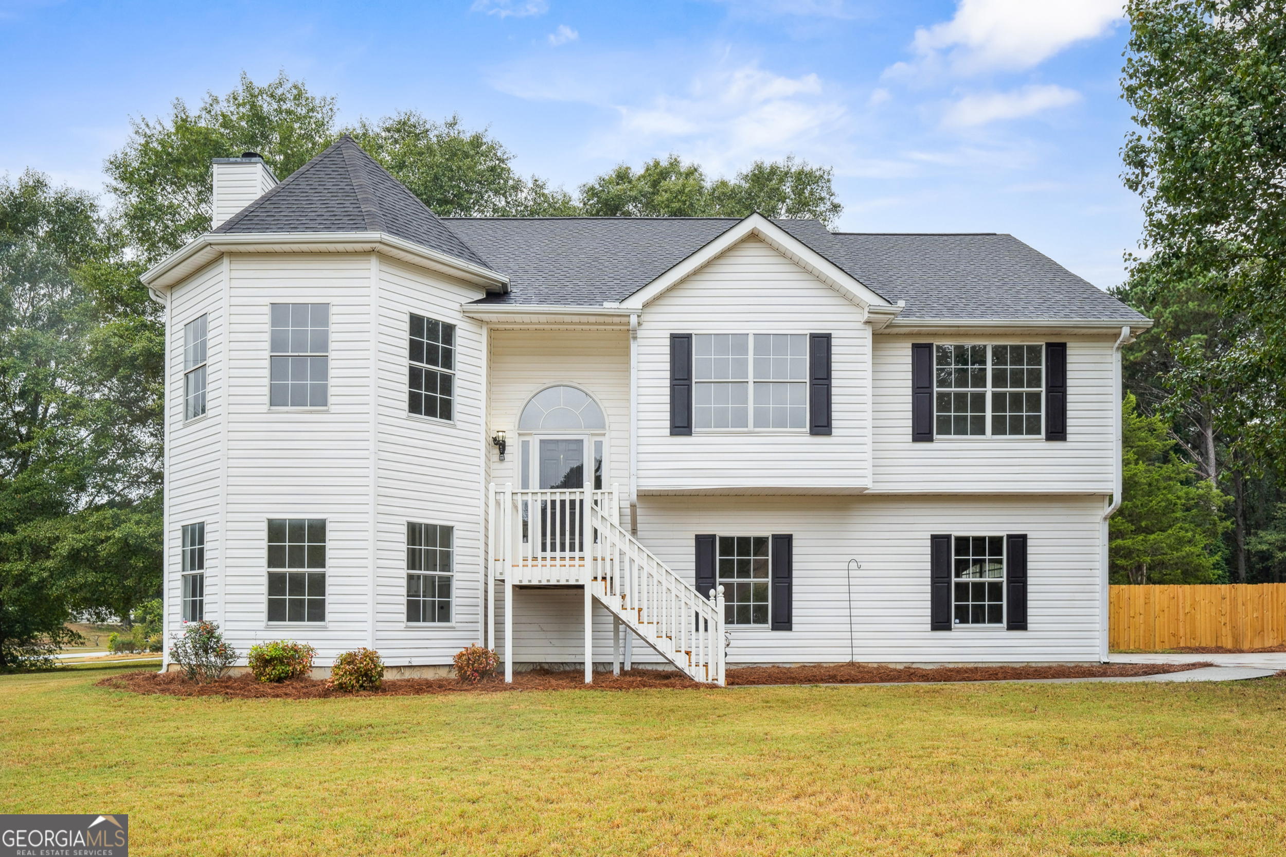 a front view of a house with glass windows and yard