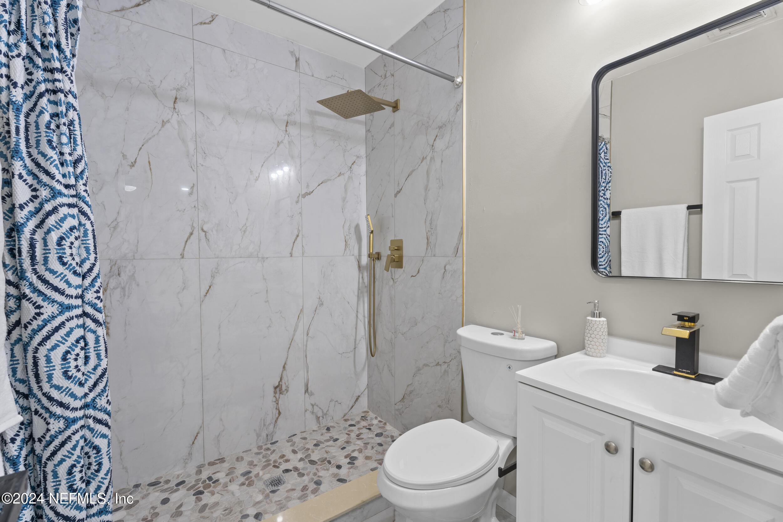 a white toilet sitting next to a bathroom sink