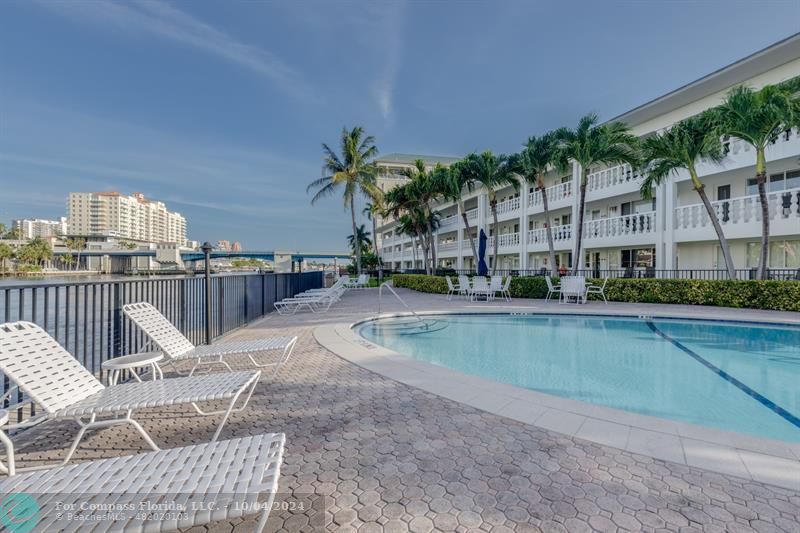 a view of a swimming pool with a patio