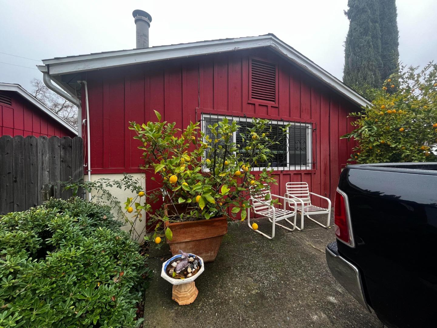 a view of a chairs and tables in the back yard of the house