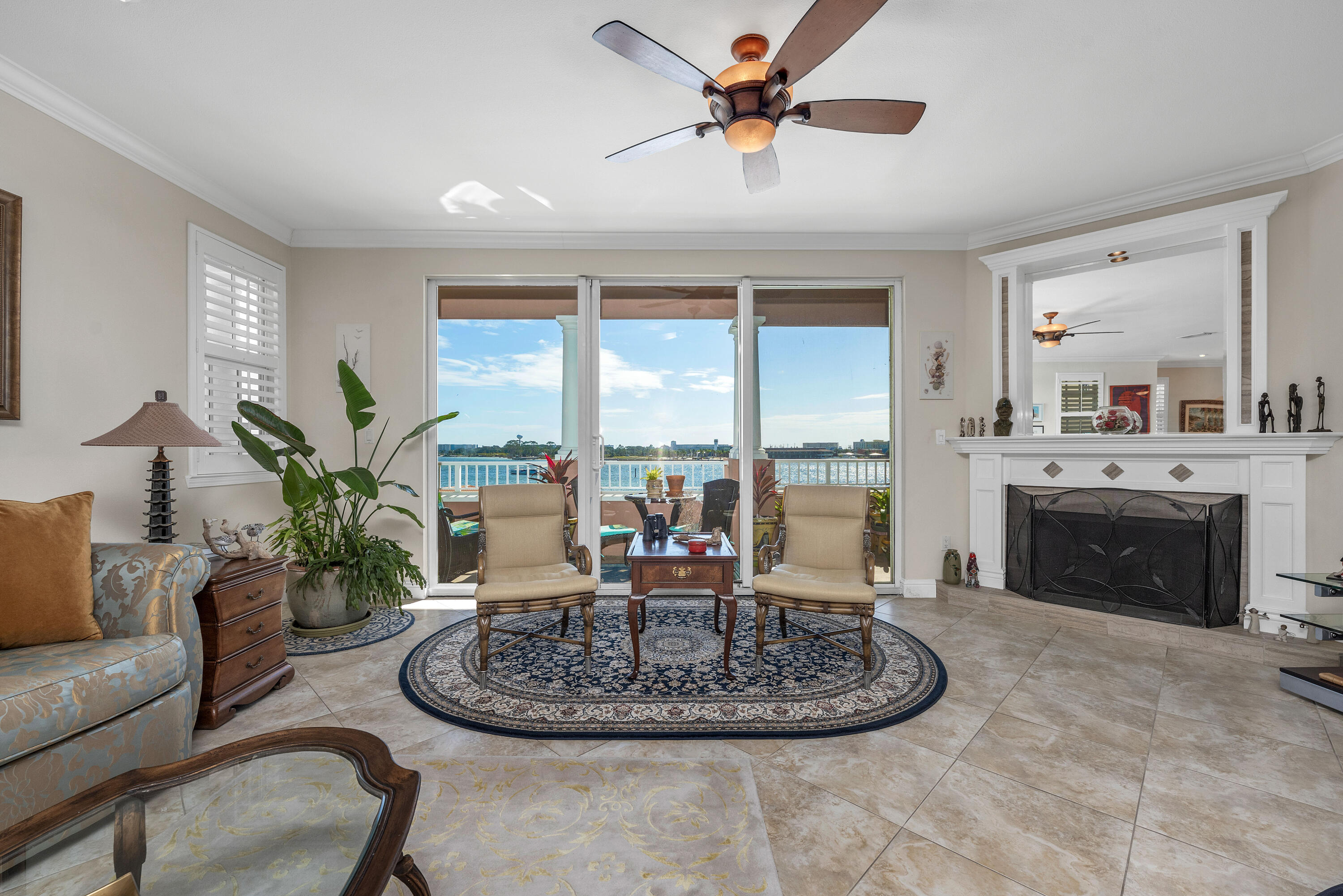 a living room with furniture a fireplace and a large window