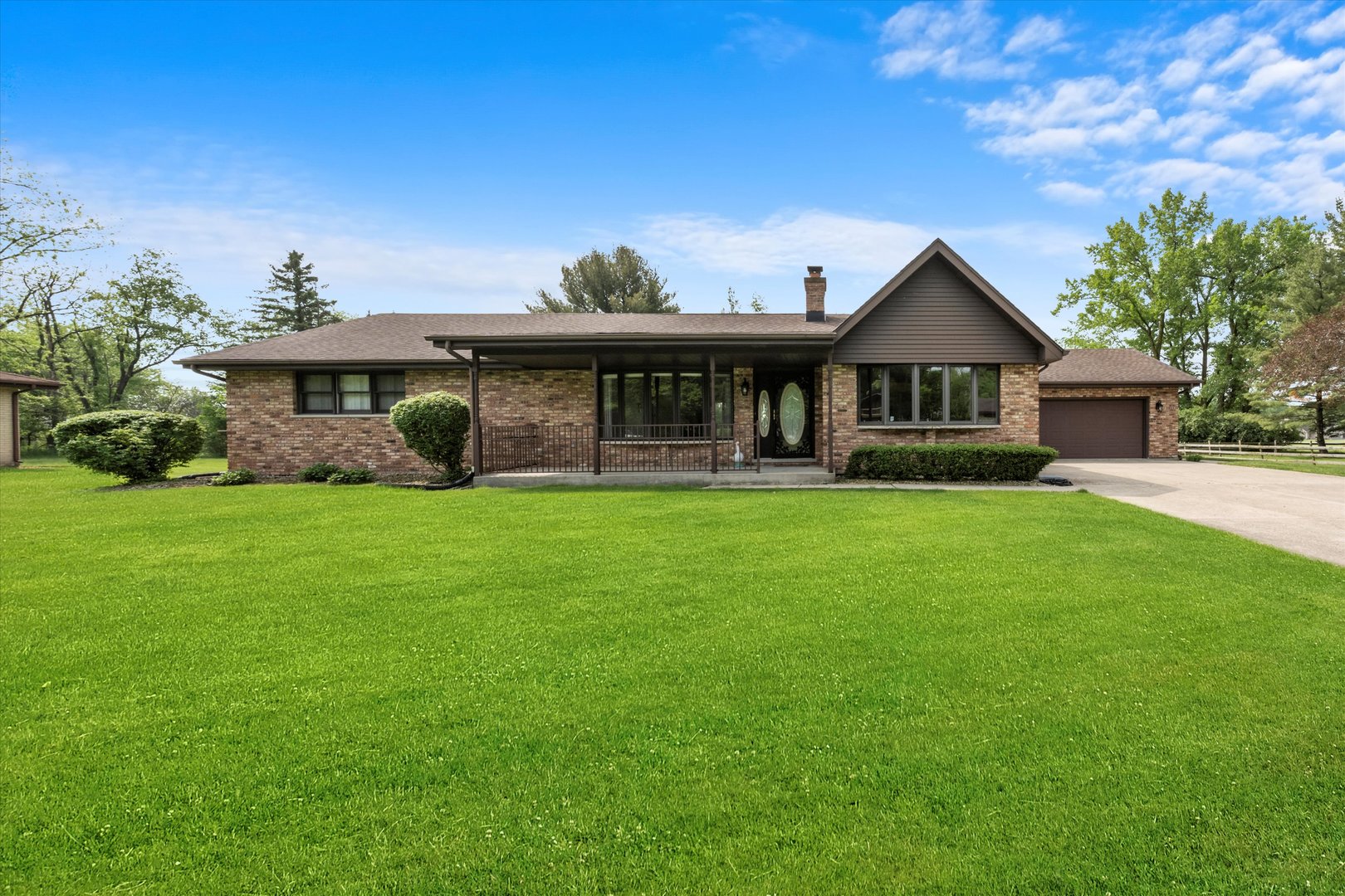 a front view of house with yard and green space