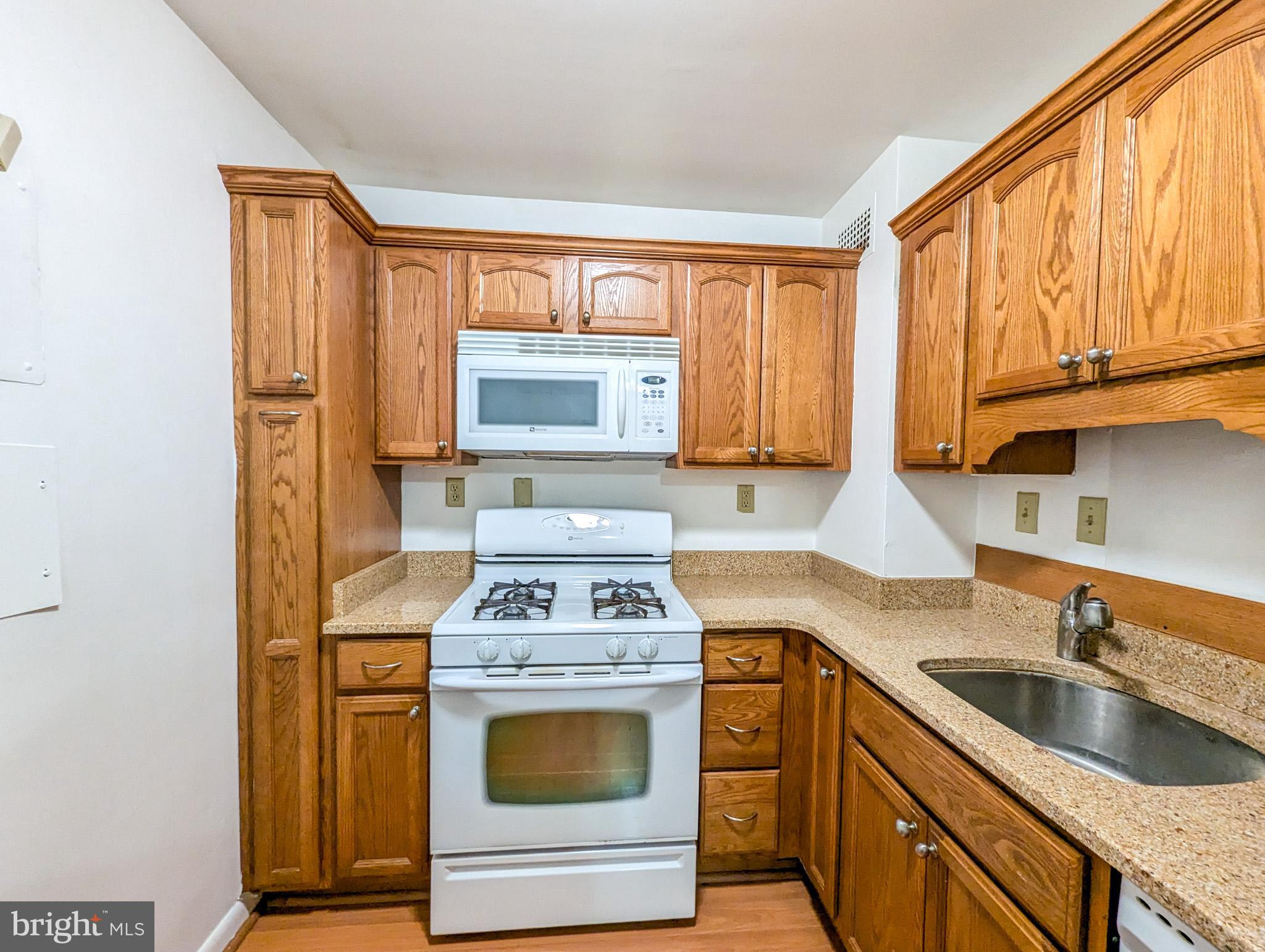 a kitchen with a stove a sink and a microwave