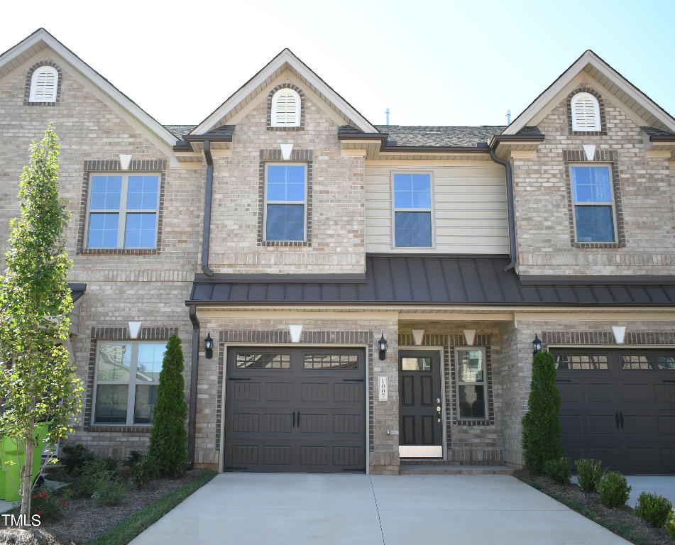 a view of a house with a yard and garage