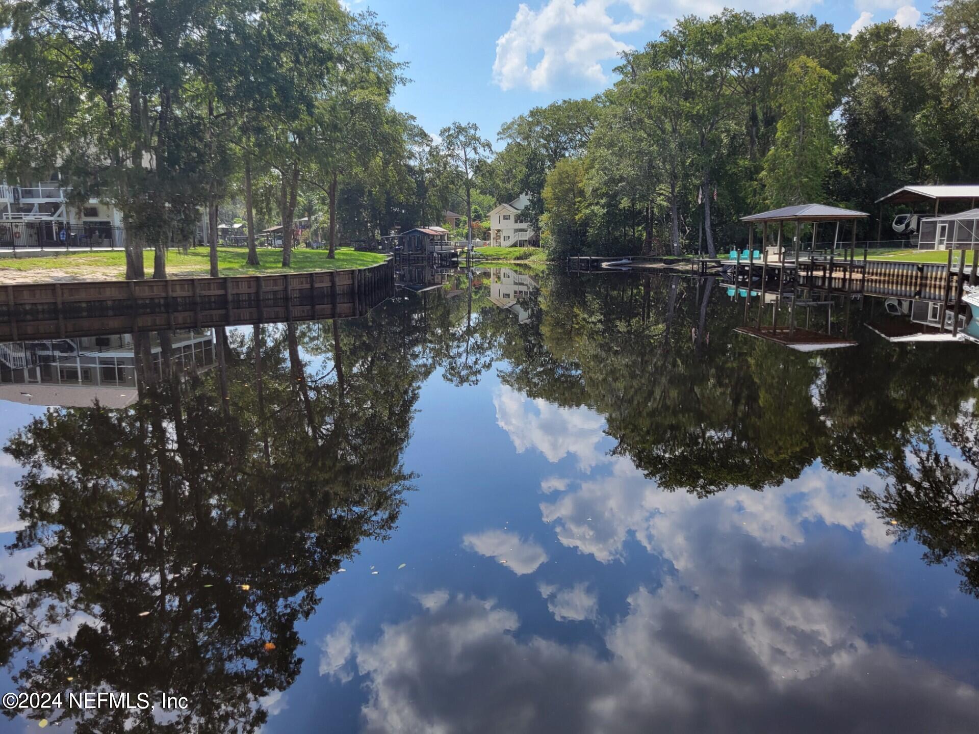 a view of a lake with wooden floor