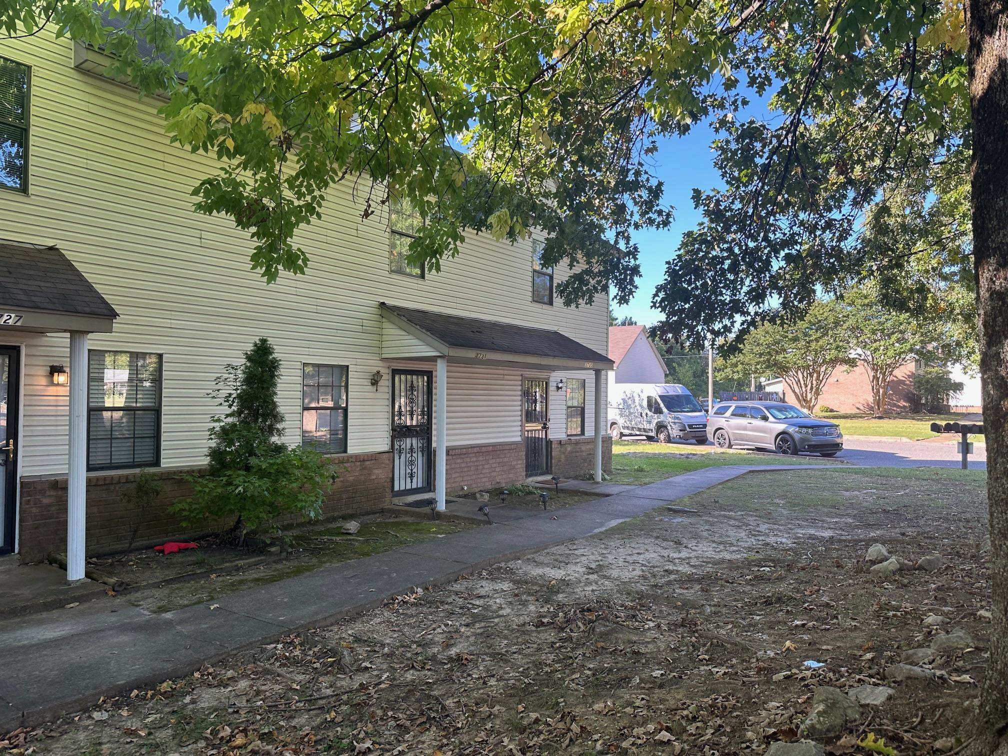 a view of a house with a yard and tree s