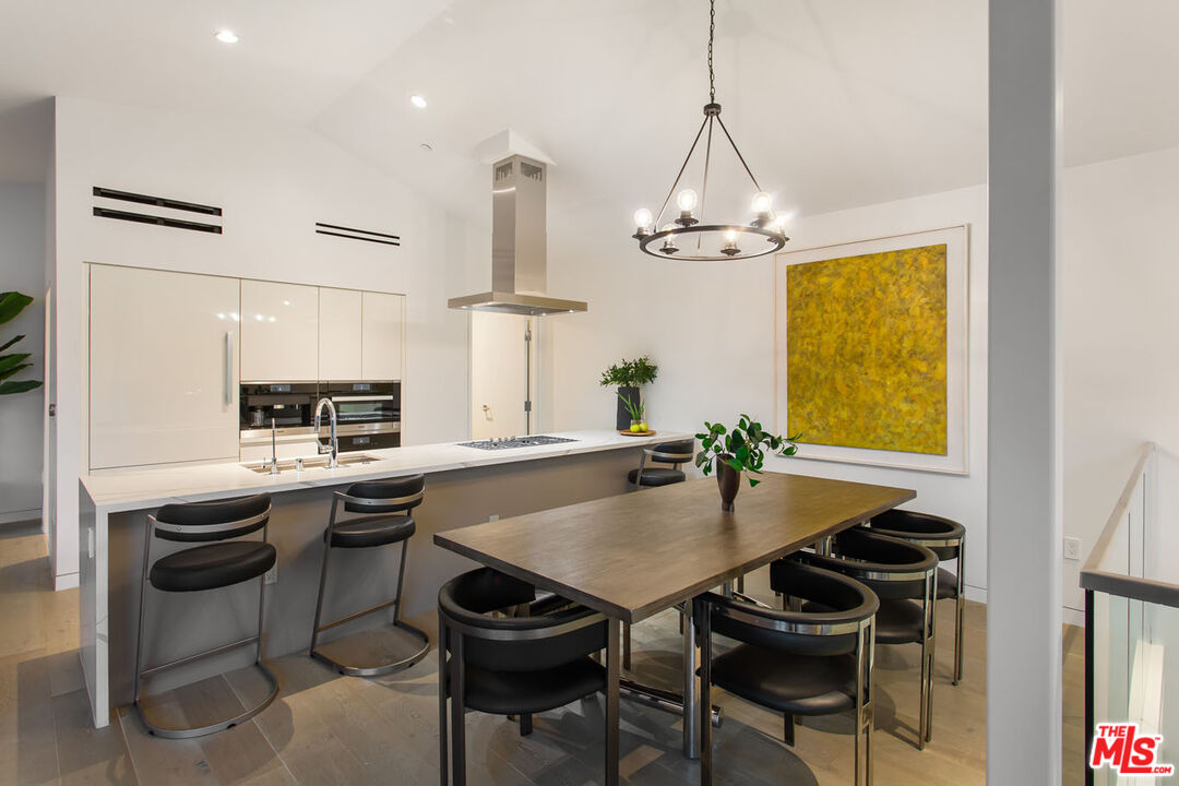 a kitchen with a table and chairs in it