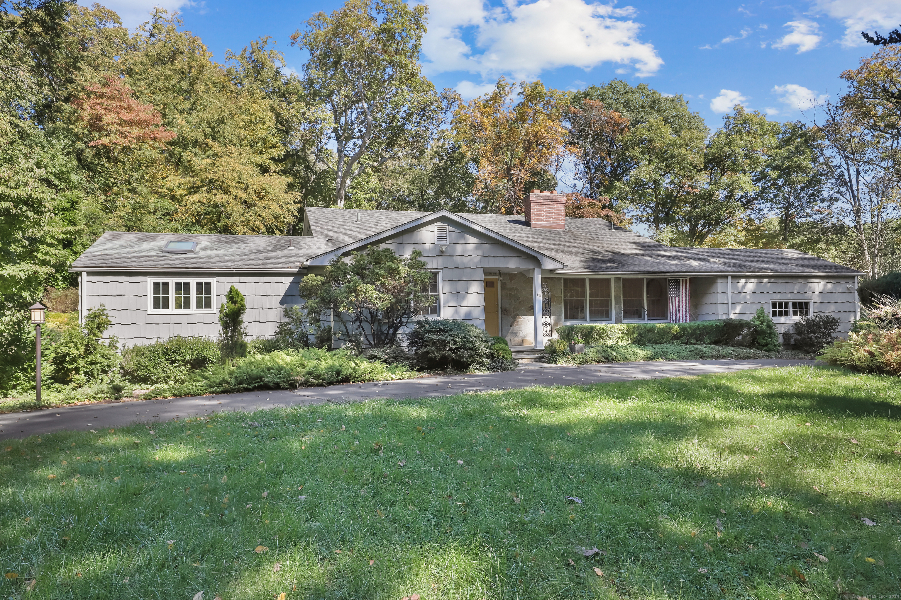 a front view of house with yard and green space