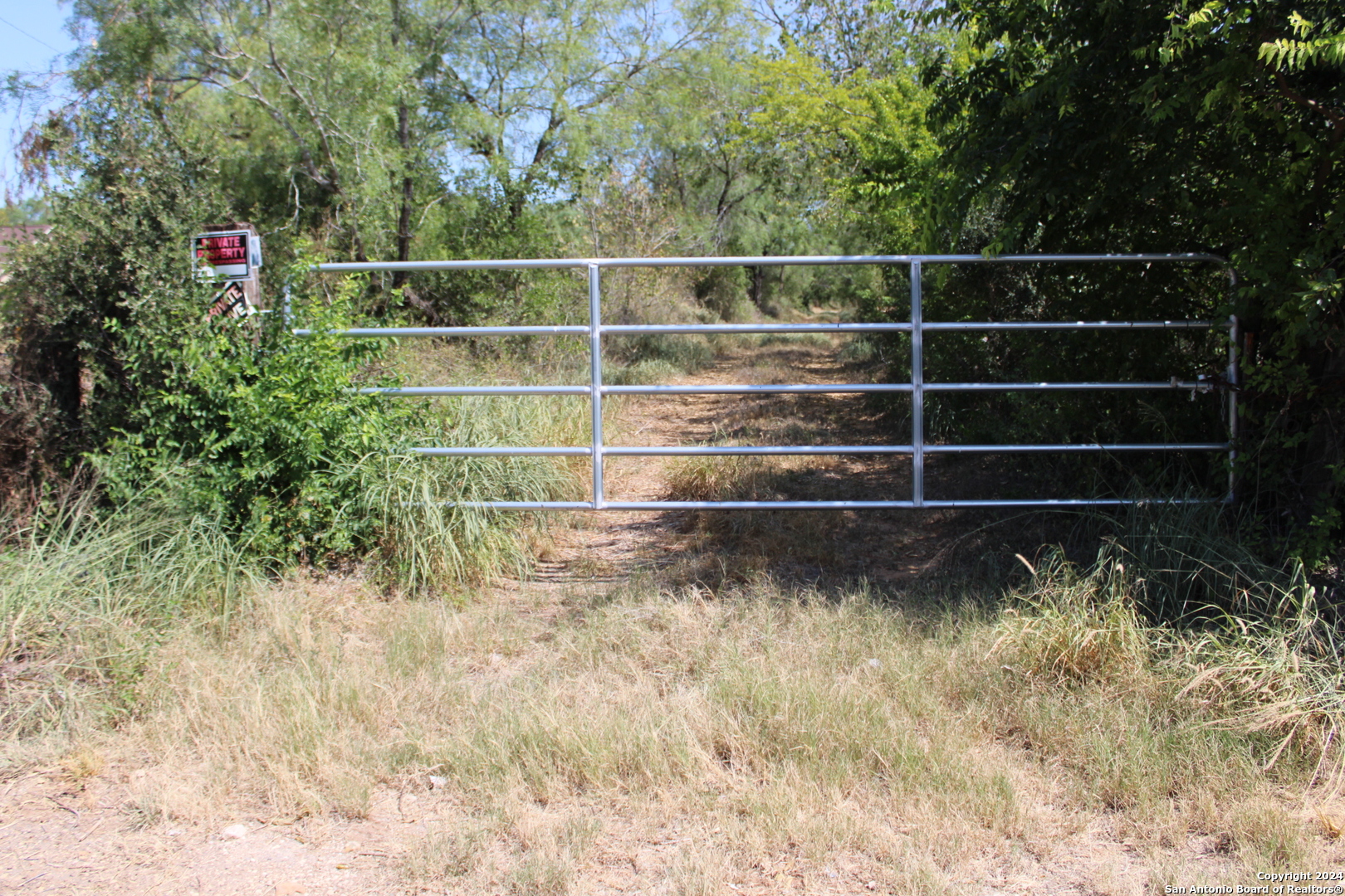 a view of a gate with a wooden fence