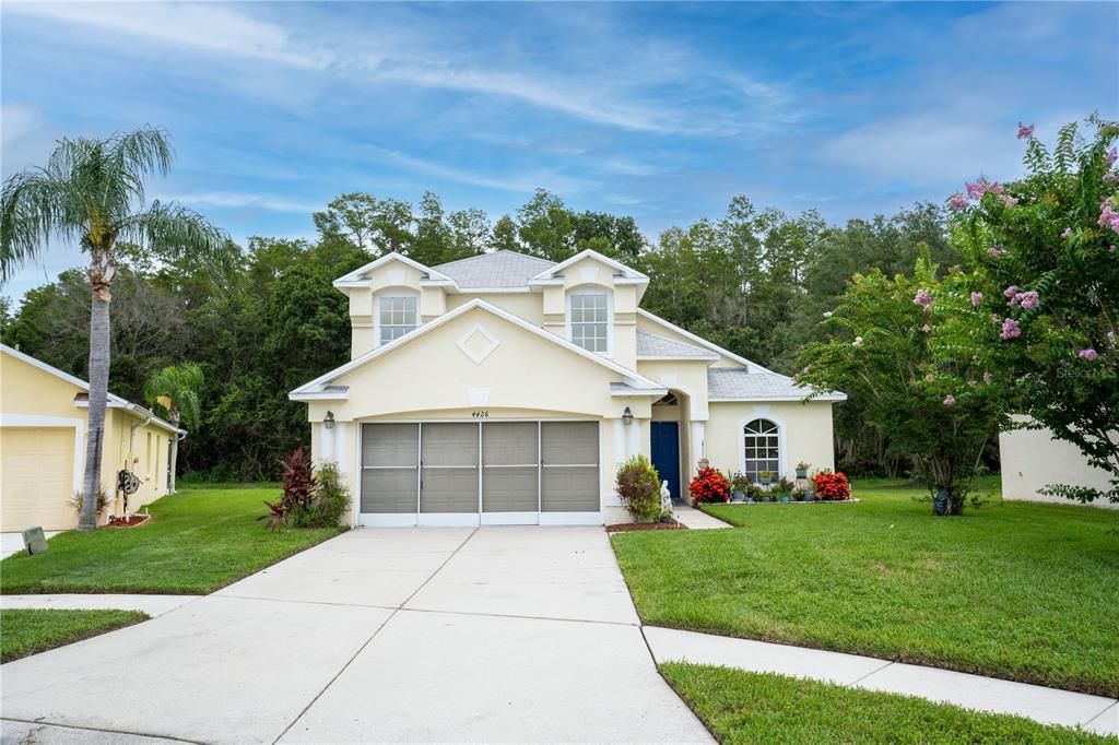 a front view of a house with a yard and garage