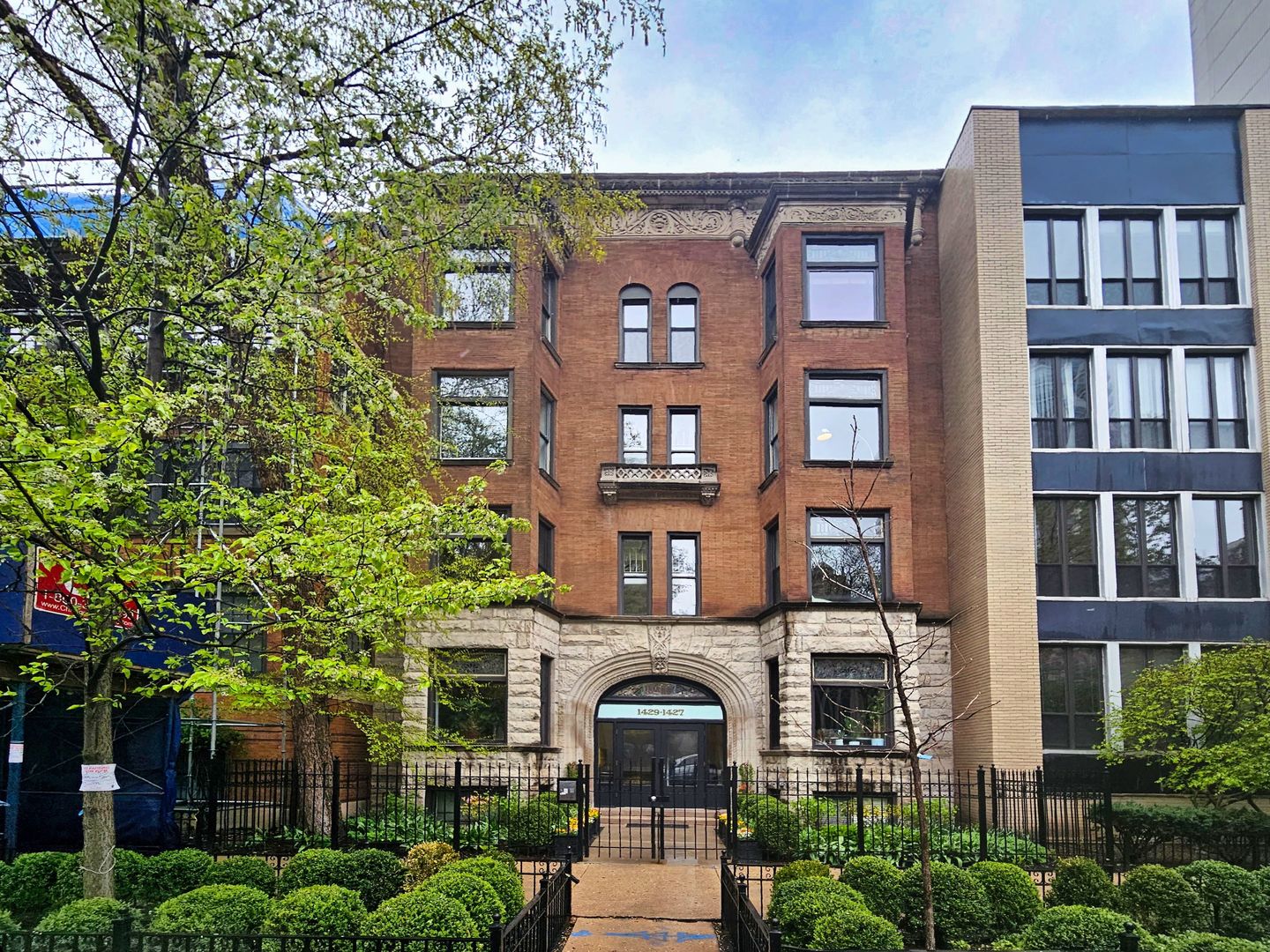 a front view of a residential apartment building with a yard