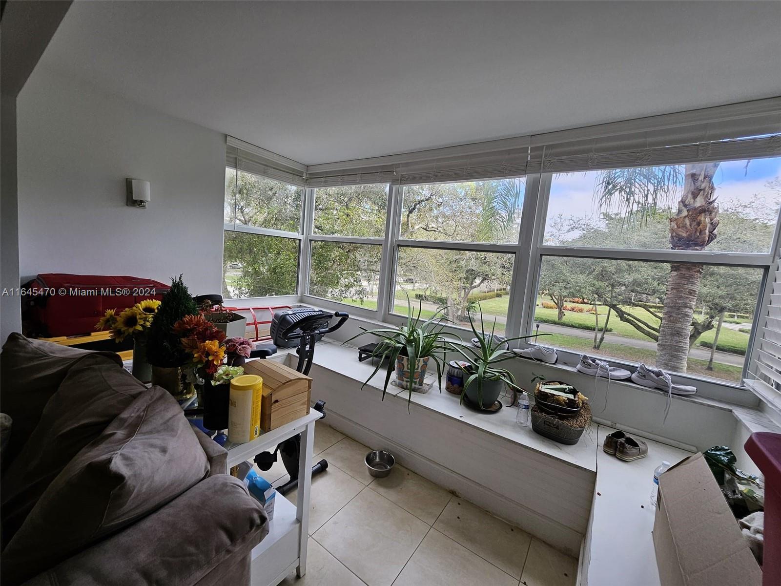 a living room with furniture and floor to ceiling windows