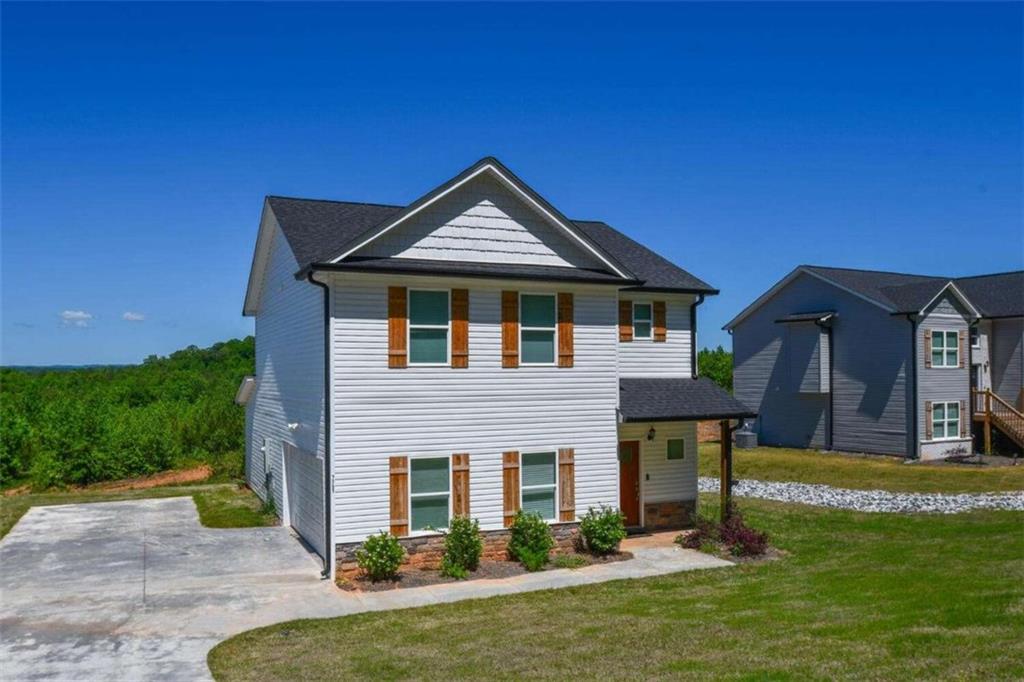 a front view of a house with a yard