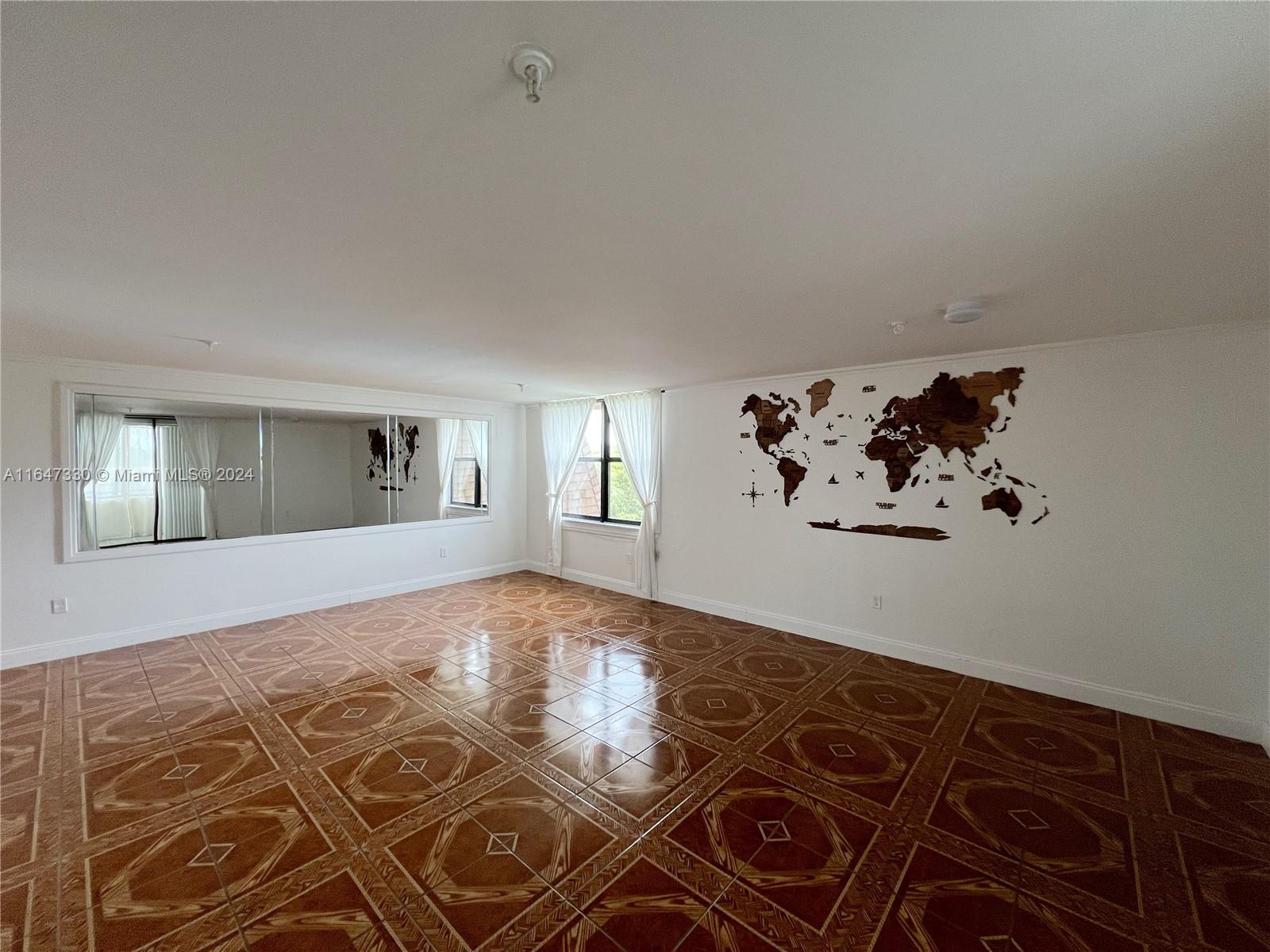 a view of a livingroom with wooden floor and a large window