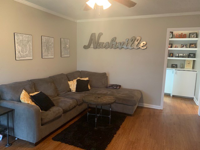 a living room with furniture and painting on the wall