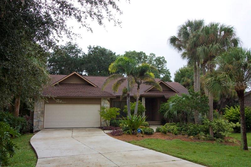 a front view of house with yard and green space