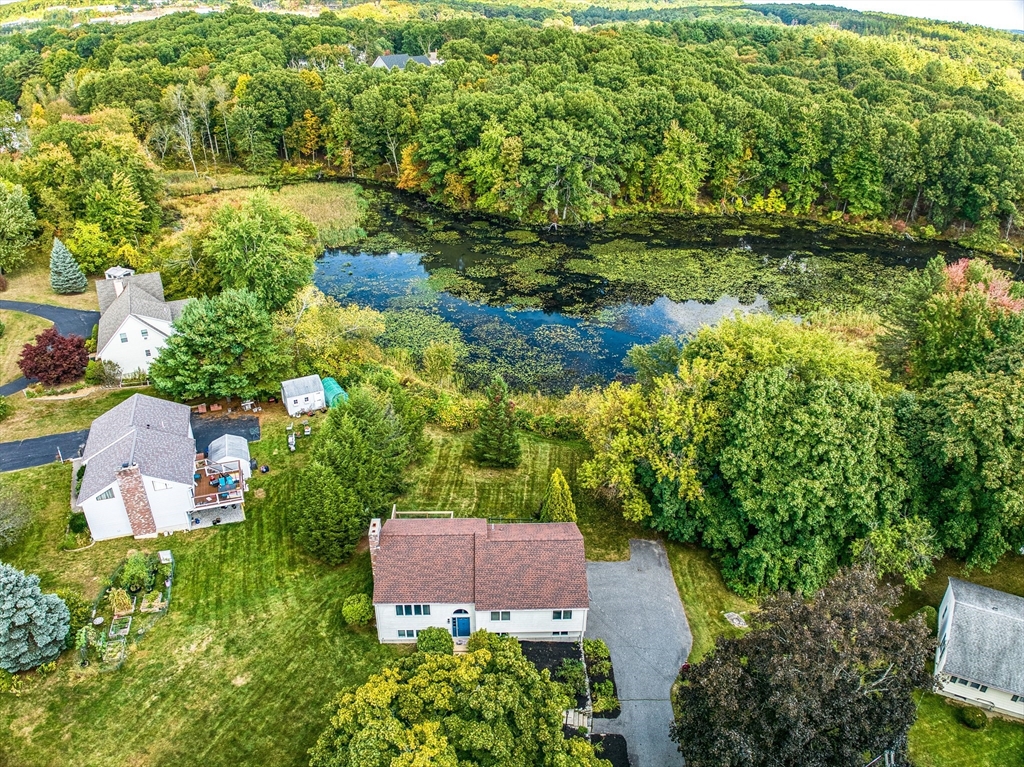 an aerial view of a house with a yard