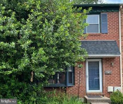 front view of a house with a tree