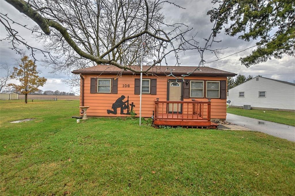 a view of a house with a yard porch and sitting area