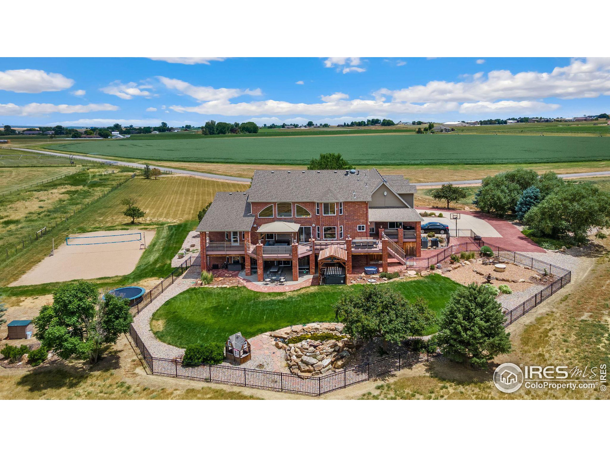 an aerial view of a house with outdoor space swimming pool and lake view