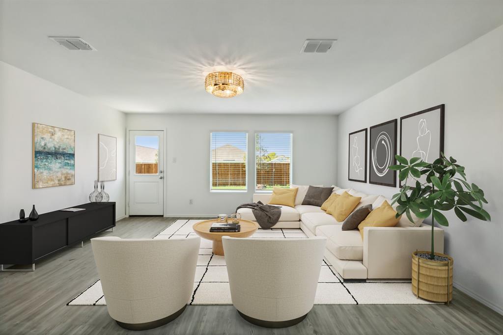 a living room with furniture and a potted plant