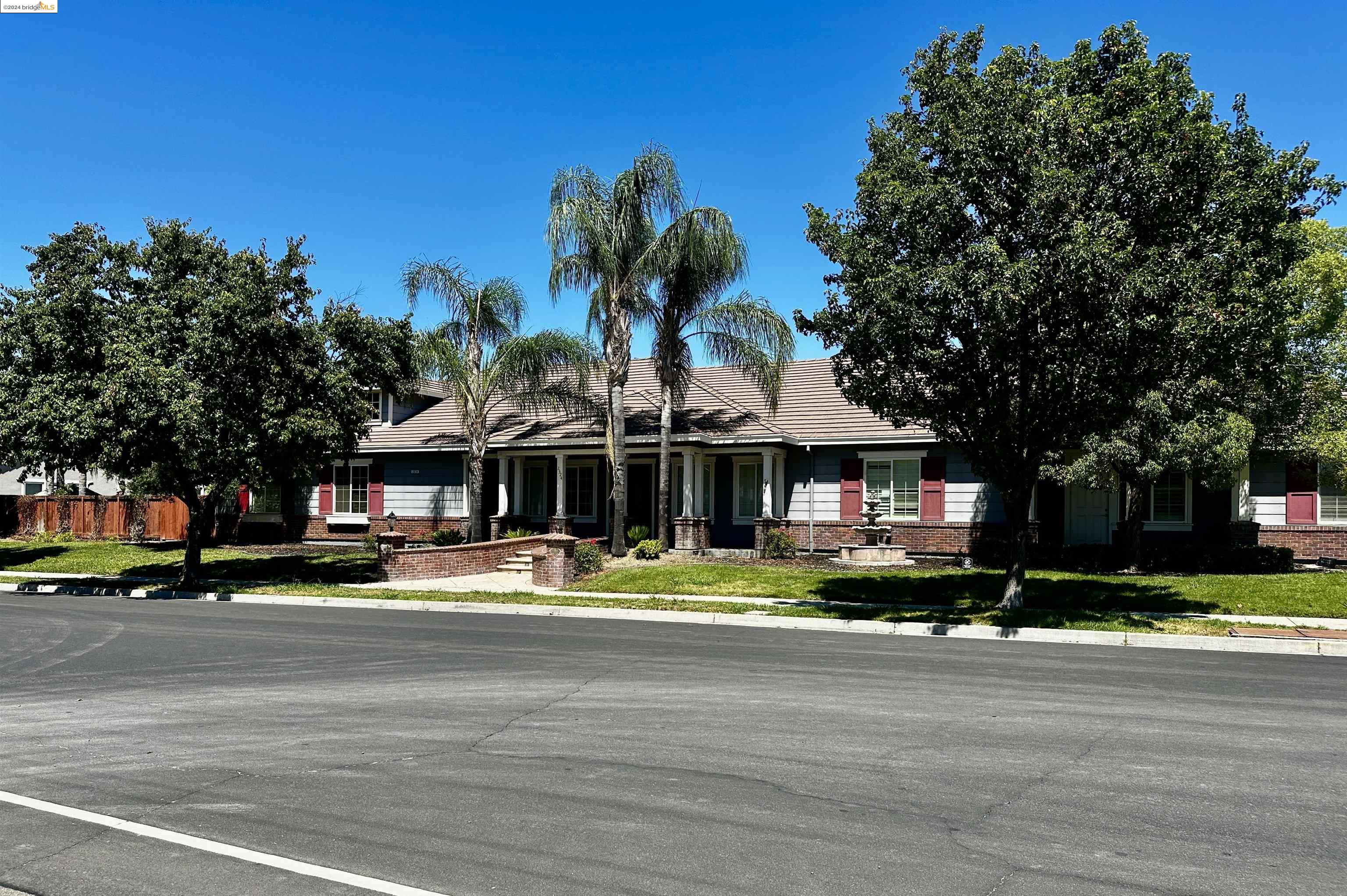 a front view of a building with trees