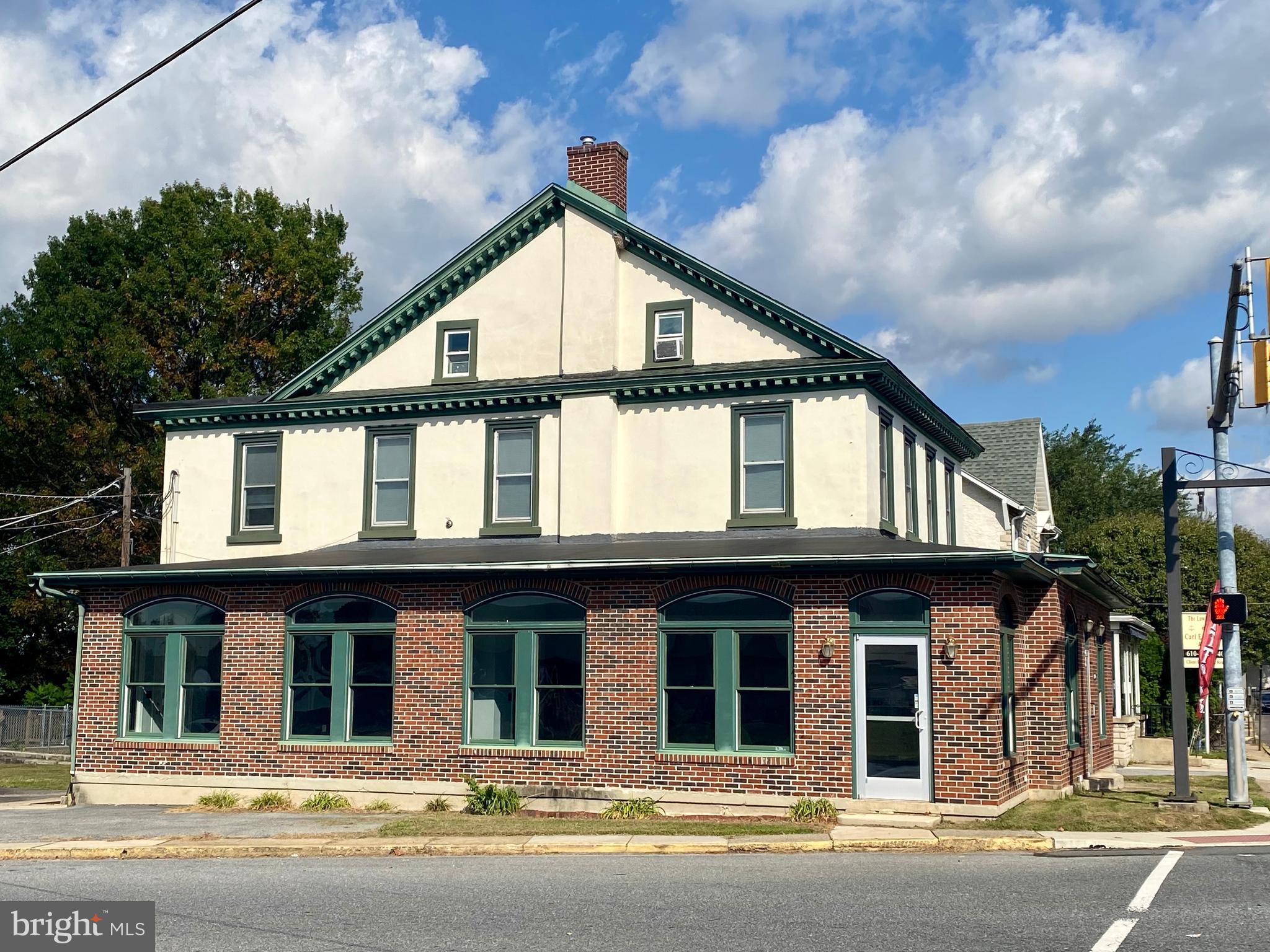 a view of a brick house with large windows