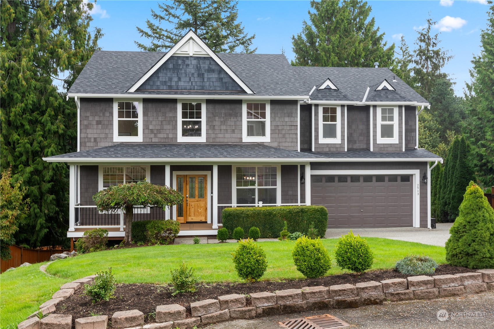 a front view of a house with a garden