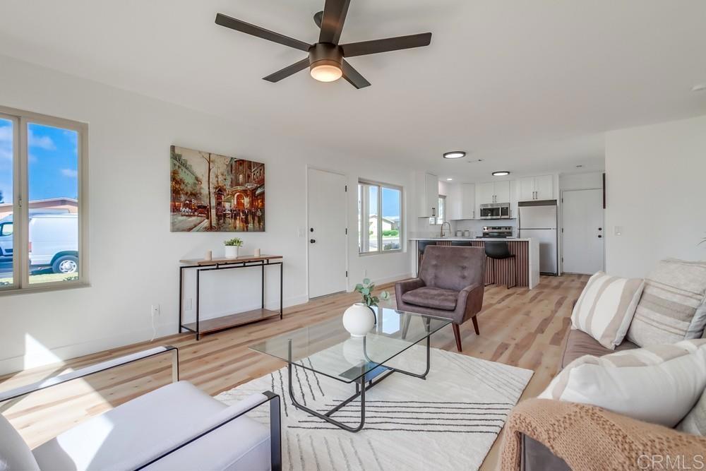 a living room with furniture and kitchen view